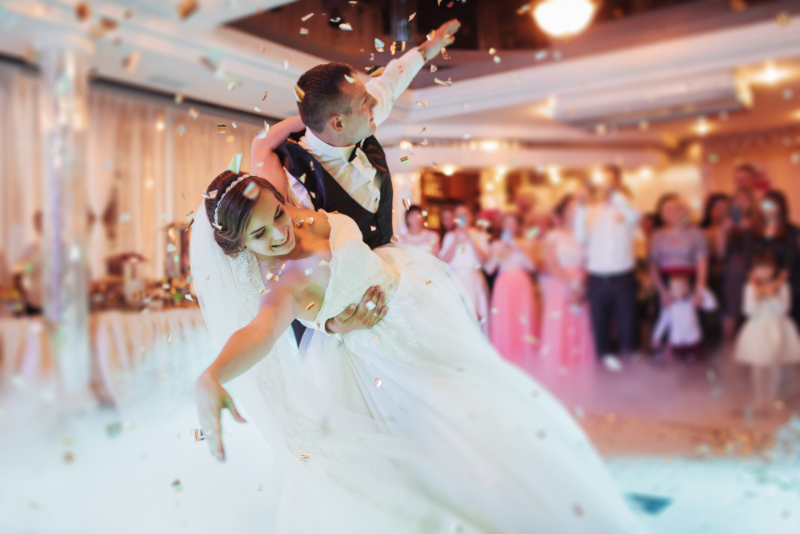 Happy bride and groom and their first dance, wedding in the elegant restaurant with a wonderful light and atmosphere